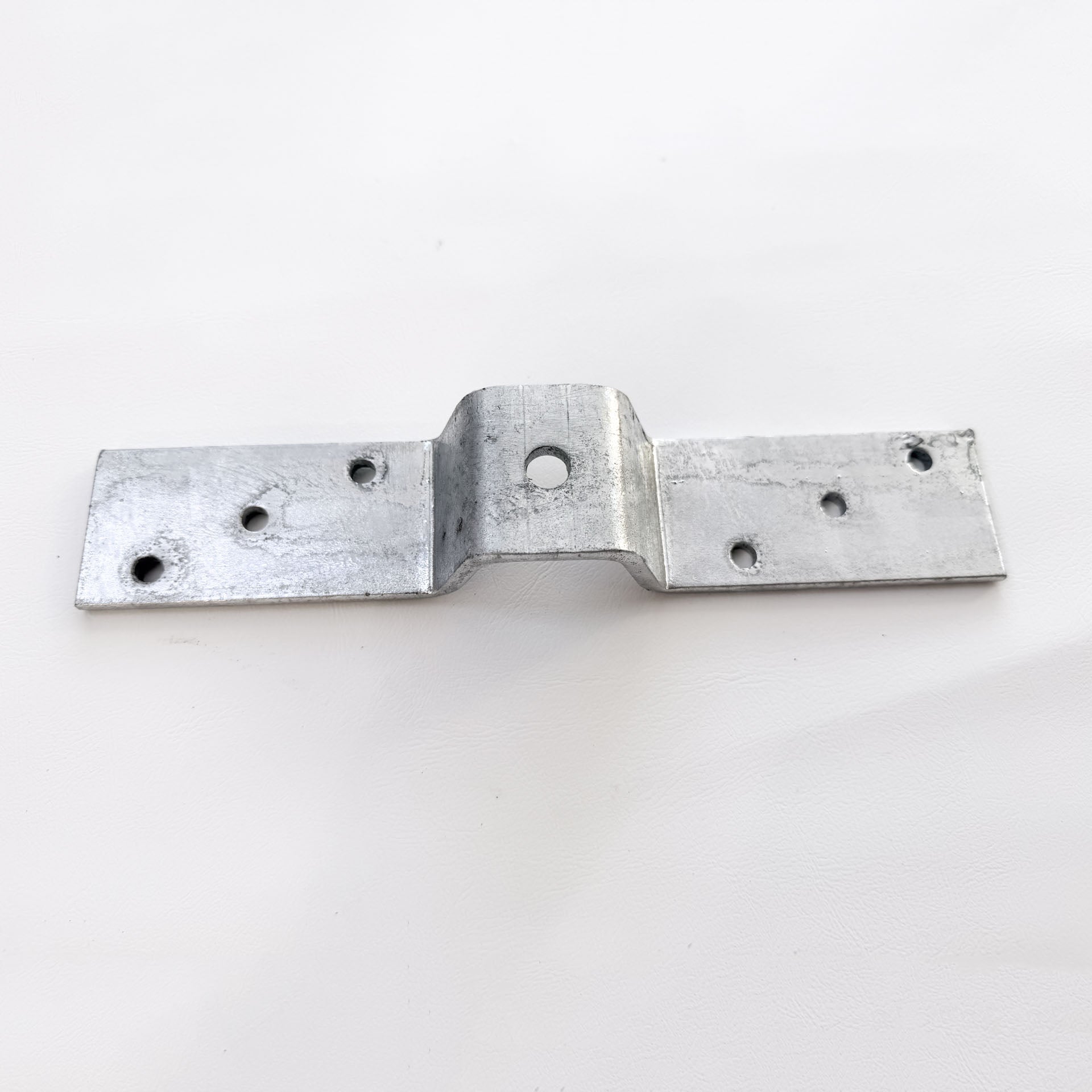 Stainless steel corrugated roof bracket with fixing holes and raised centre section