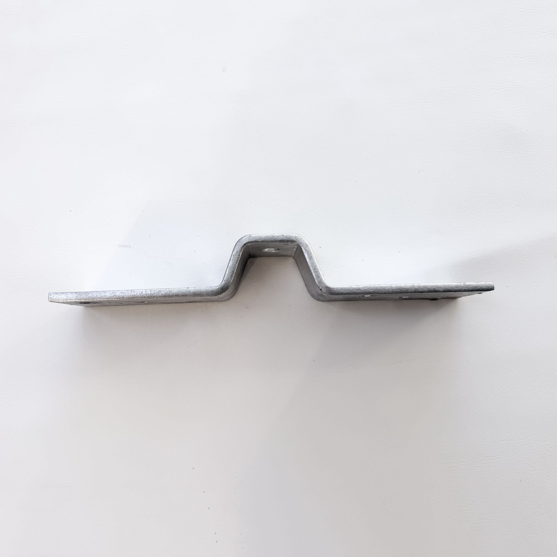 Side profile of stainless steel corrugated roof bracket showing the shaped centre