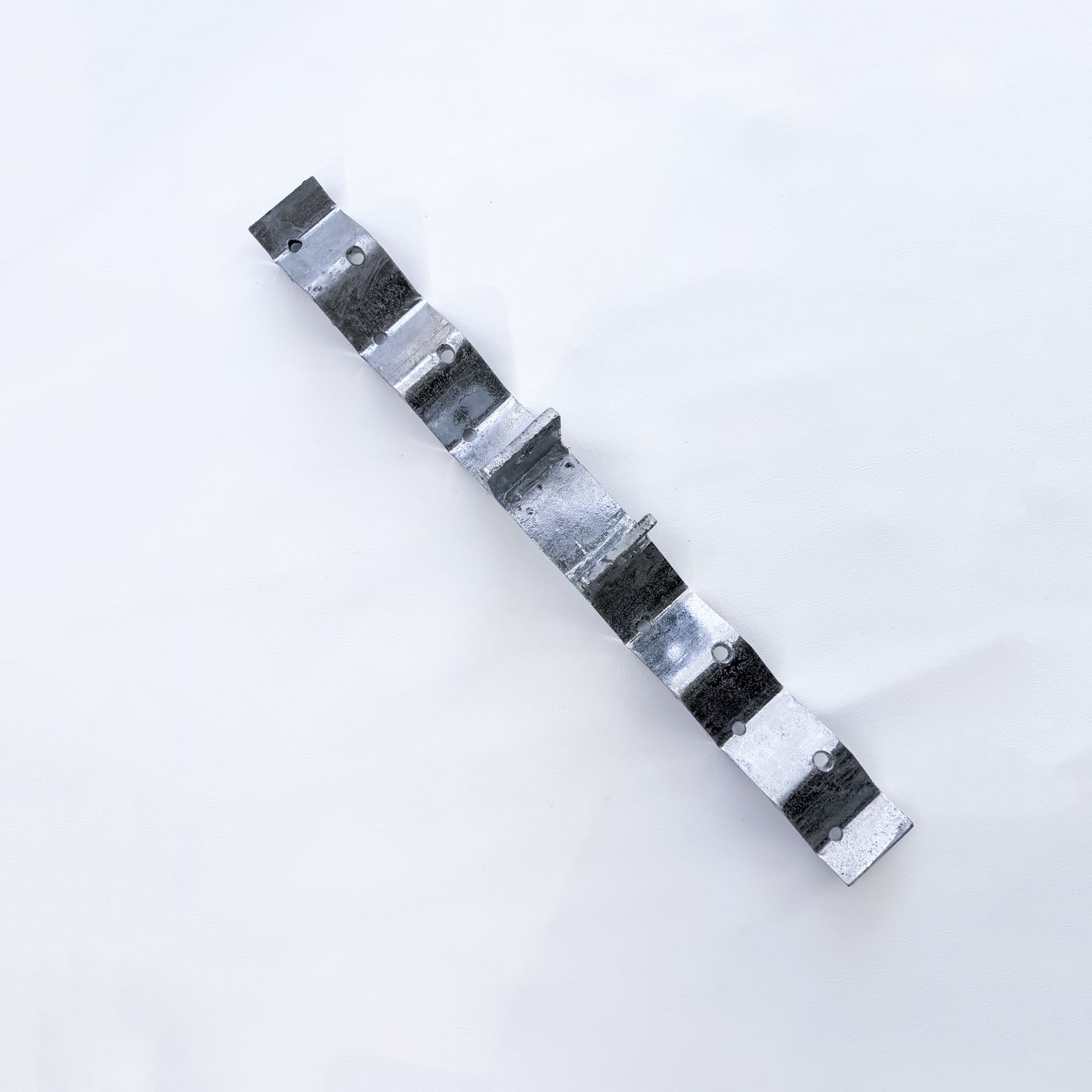 Angled view of galvanised roof bracket showing the raised post and corrugated shaping