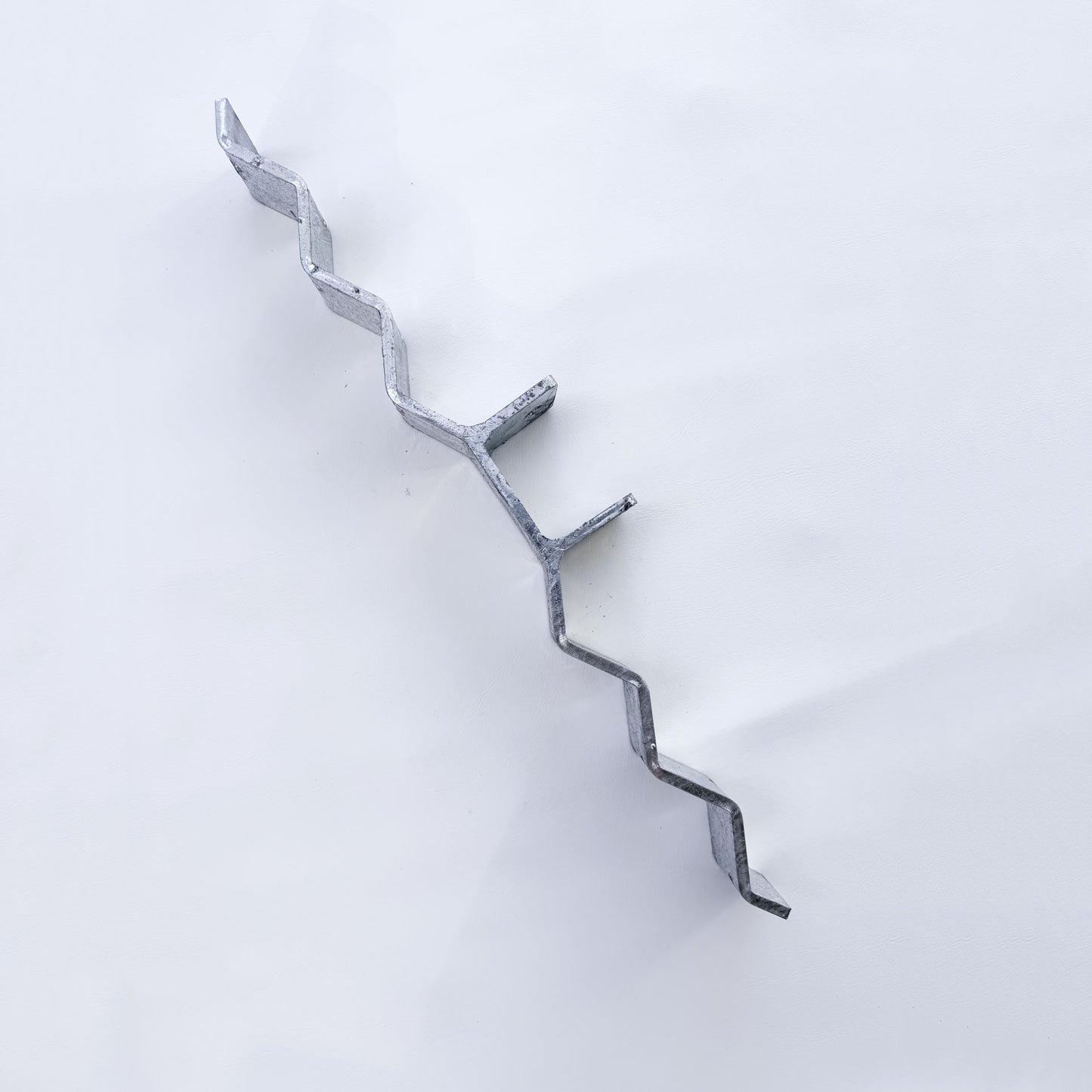 End view of galvanised roof bracket showing the post height above the corrugated profile