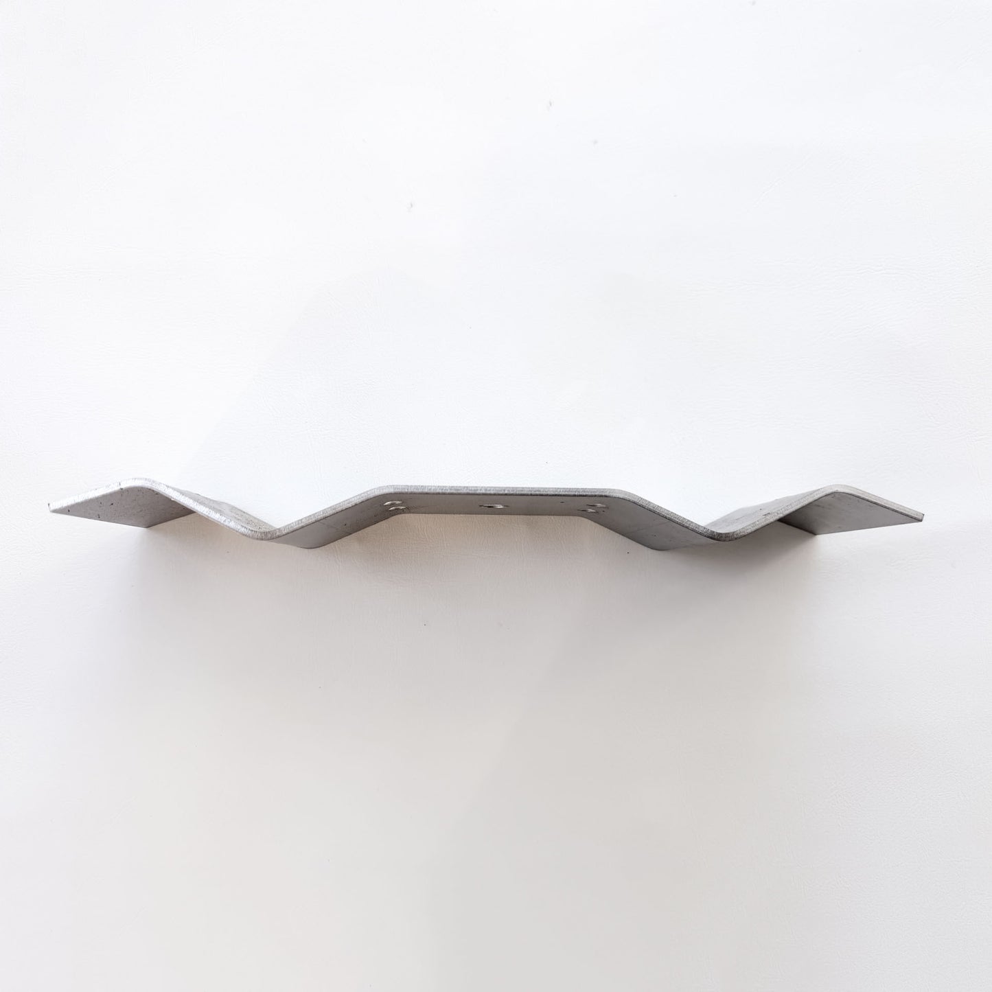 Side profile of galvanised Trimdeck roof bracket showing the ribbed shaping